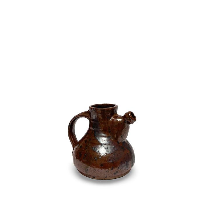 Brown speckled ceramic jug with curved handle and short spout