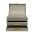Ivory 3-tier faux leather jewelry box in ivory with champagne gold handles, featuring multiple compartments for jewelry storage.