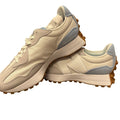 New Balance 327 Retro sneakers for women in beige, cream, and grey, featuring classic design and cushioned soles.