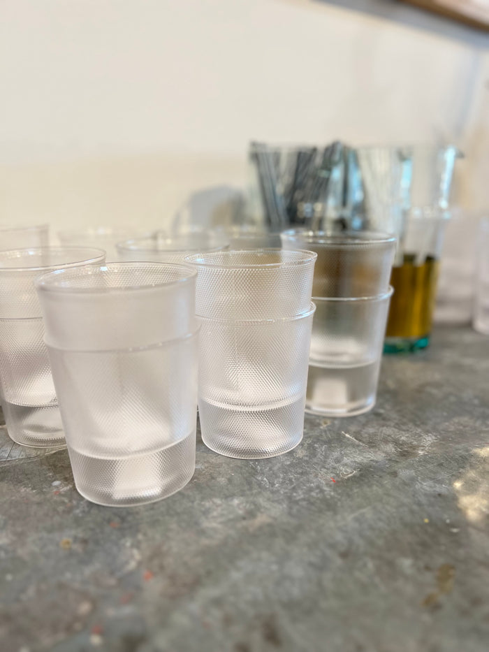 Set of La Nouvelle glass tumblers, clear cups with dotted texture on table