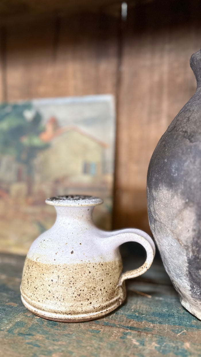 Studio pottery vase with short neck, flared lip, speckled tan and gray, side handle.