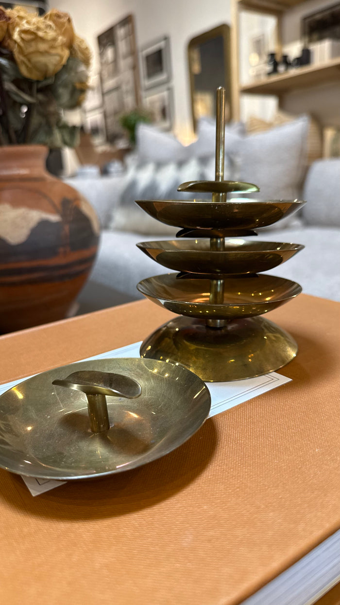 Brass ashtray stack display with central stem and three round dish trays