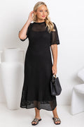 Airlie crochet dress in black, open-weave knit dress with short sleeves, styled with a black leather bucket bag and printed slide sandals