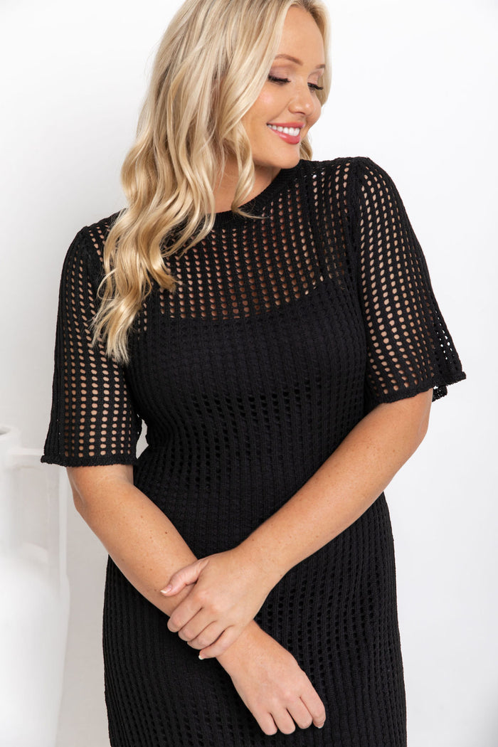 Airlie crochet dress in black, open-weave knit dress with short sleeves, styled with a black leather bucket bag and printed slide sandals