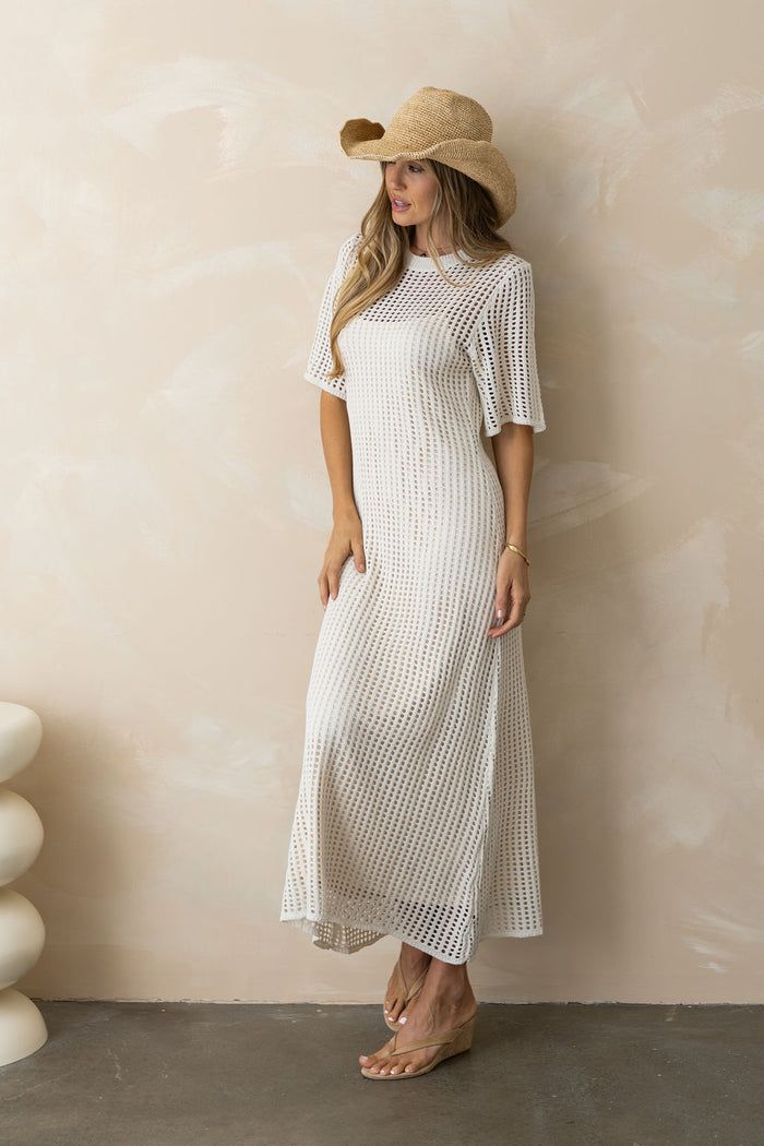 Airlie crochet midi dress in natural, open-weave knit midi dress with short sleeves, styled with thong heeled sandals and a summer hat