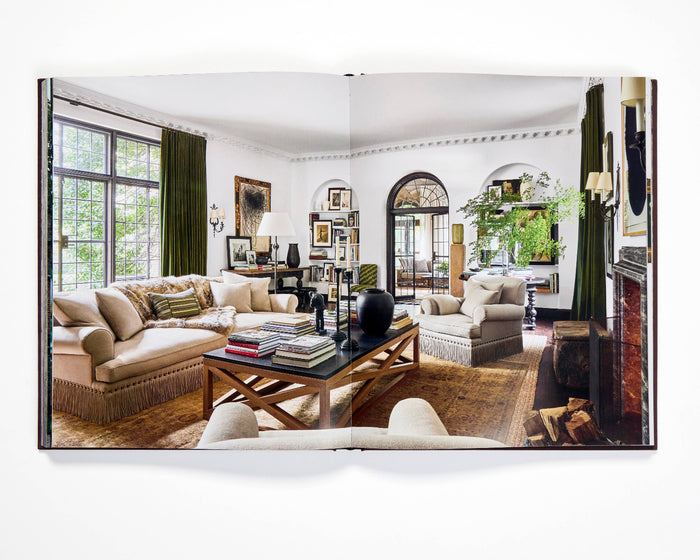 Open photo book spread with two living room images and beige sofa set