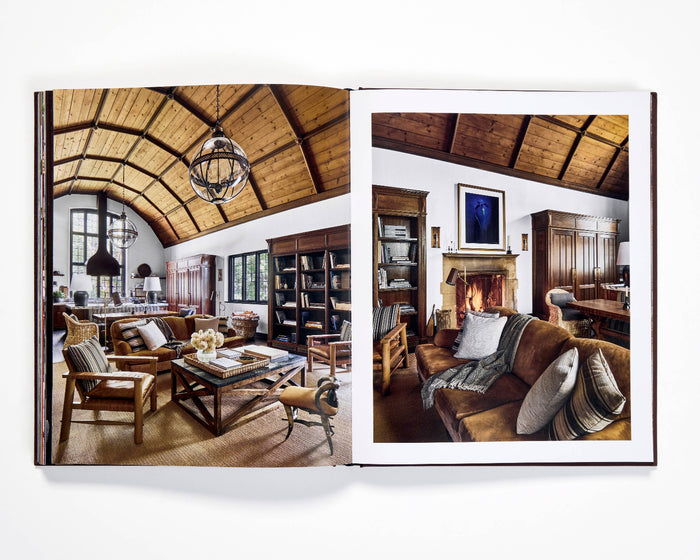Open photo book spread showing dining and lounge room scenes with wooden ceiling beams