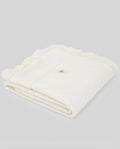 Folded white towel on a light gray background