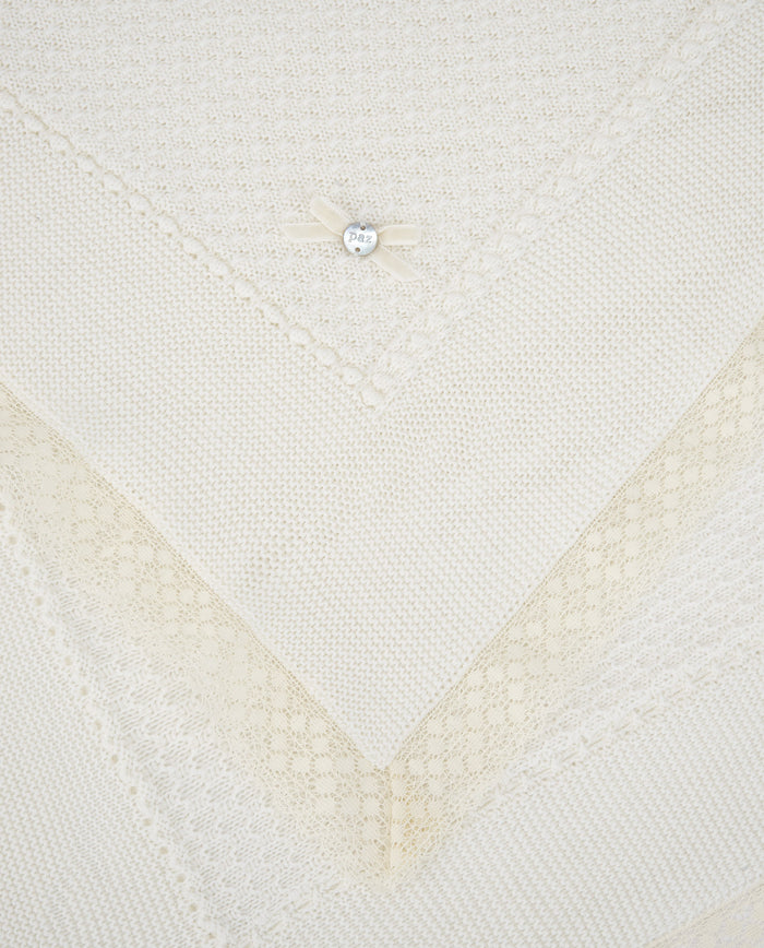 Close-up of a textured white fabric with a diamond pattern