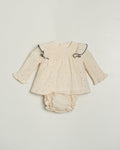 Baby outfit with long-sleeve top and diaper on a light gray background