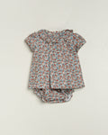 Floral baby outfit with top and bloomers on a light gray background