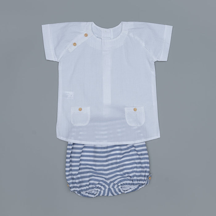 White shirt with button details and striped shorts on a gray background