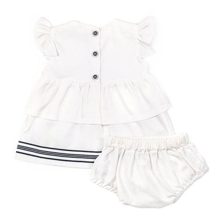 White baby dress with ruffled sleeves and bloomers on a white background