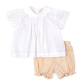 White blouse with yellow ruffled shorts on a white background