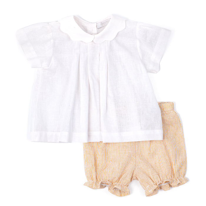 White blouse with yellow ruffled shorts on a white background