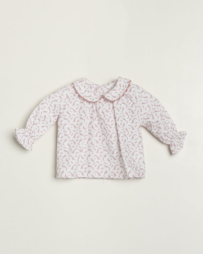 Baby blouse with floral pattern on a white background