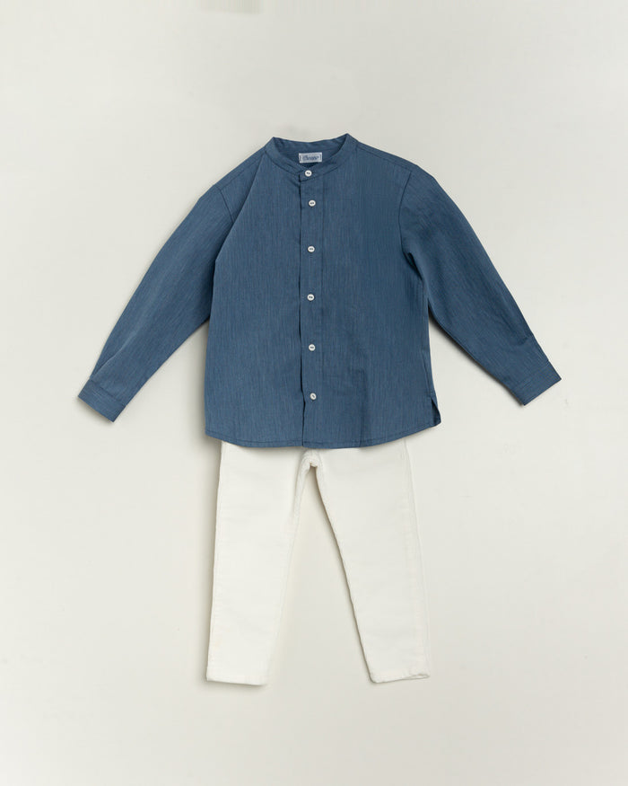 Blue shirt and white pants on a light gray background