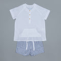 White shirt with buttons and striped shorts on a gray background