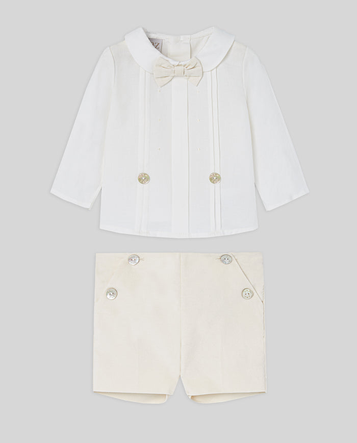 White shirt with bow tie and shorts on a light gray background