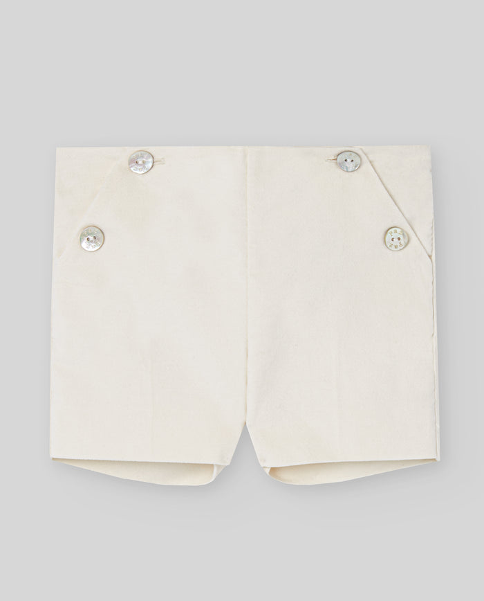 White shorts with button details on a light gray background