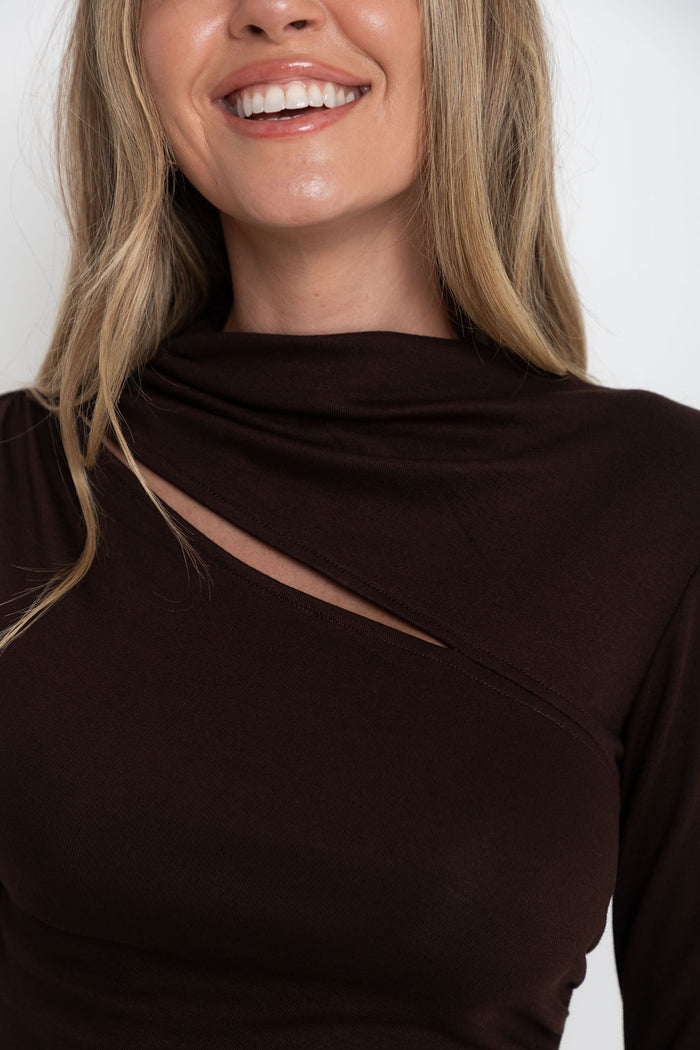Carolyn long sleeve top in chocolate brown, fitted top with asymmetric cutout neckline, styled with a denim skirt