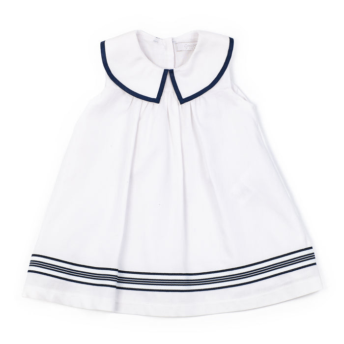 White dress with navy trim on a white background
