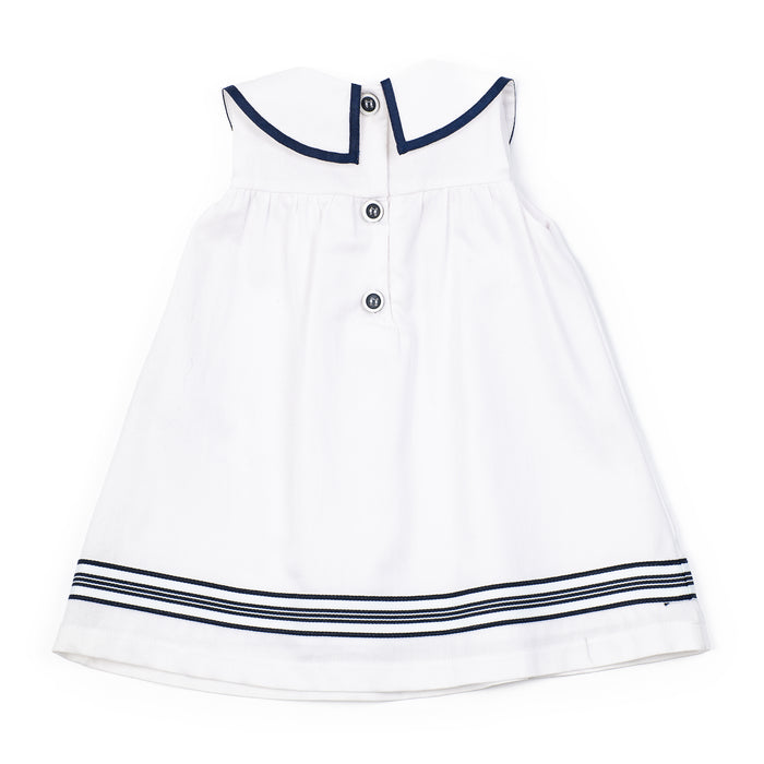 White dress with navy trim on a white background