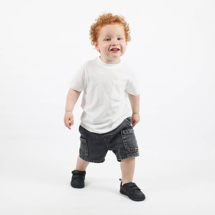Studio shot of toddler wearing black barefoot trainers