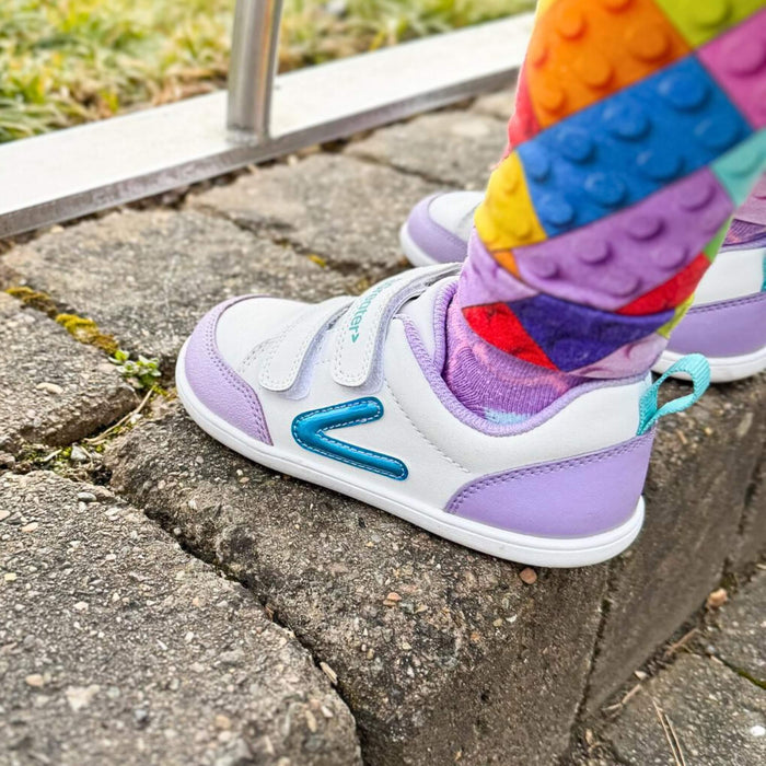 Toddler wearing Purple Barefoot Trainer In Park Close Up