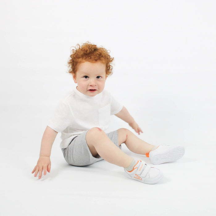 Studio shot of boy wearing white barefoot trainers