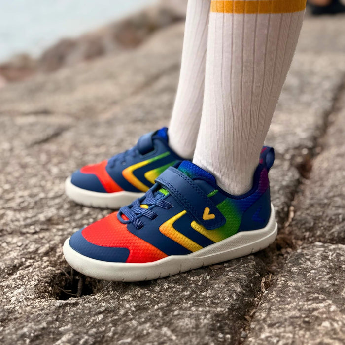Close up rainbow barefoot trainers standing up on rocks
