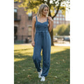 Free People Movement misty blue women's jumpsuit, medium size, stylish and comfortable, shown on a model.