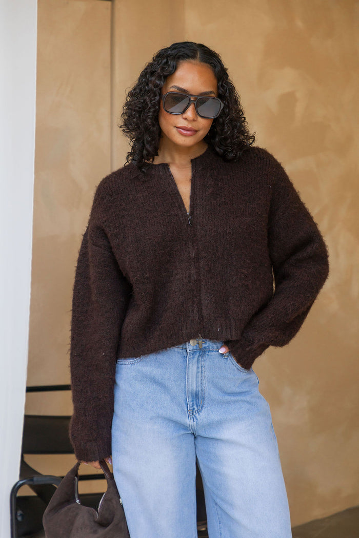 Freya Cardigan in chocolate brown, cropped fuzzy knit sweater with half-zip neckline, styled with light wash denim jeans and a brown suede bag
