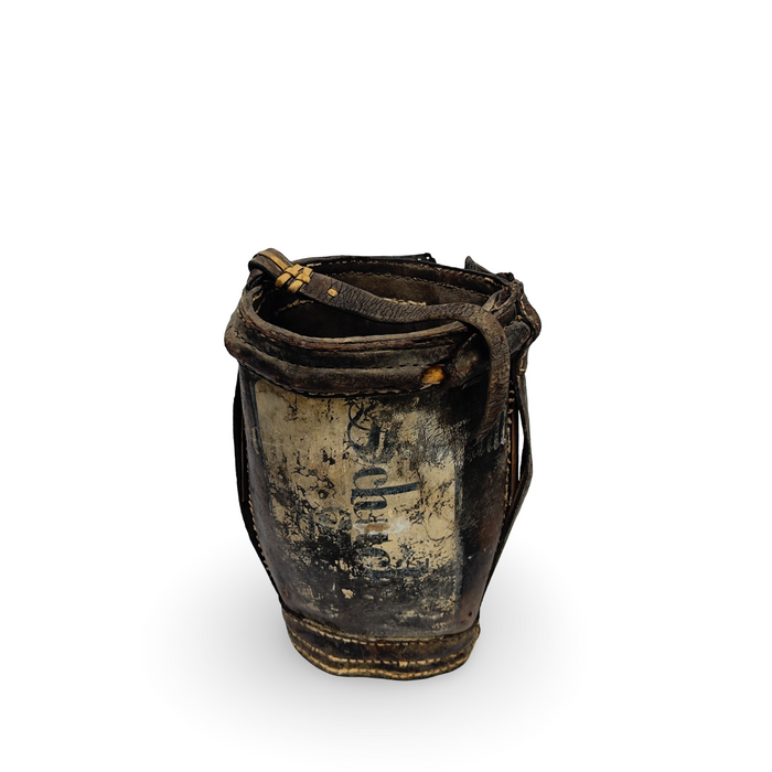 Antique metal water bucket with leather strap rim and rope handle, dark patina