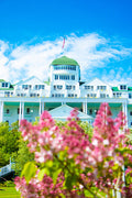 Lilacs & Grand Hotel's Cupola by Jennifer Wohletz.  Photography on canvas mounted on black styrene. 10" x 15"  Description:  Lilacs bloom in the Tea Garden beneath the Grand Hotel.  An American flag waves above the hotels cupola.