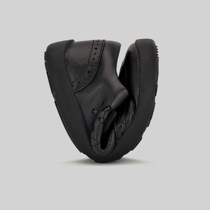 Matte black barefoot girls school shoe - flexed