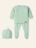 Green baby outfit with matching hat on a white background