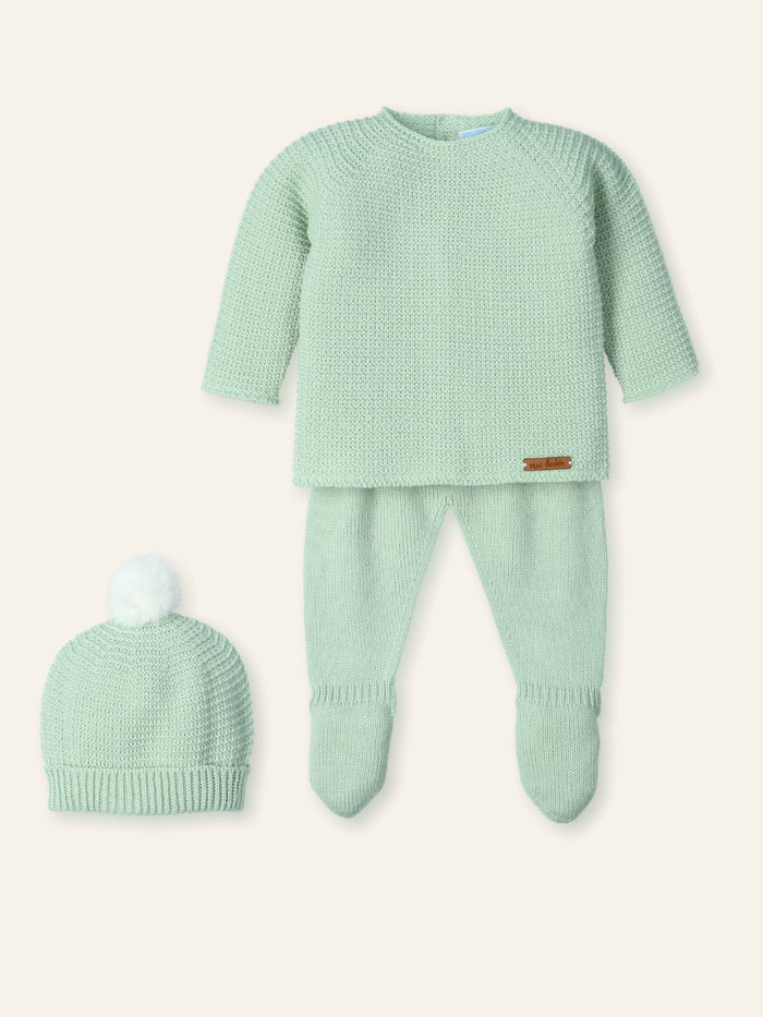 Green baby outfit with matching hat on a white background