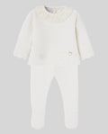 White baby set with lace details on a light gray background