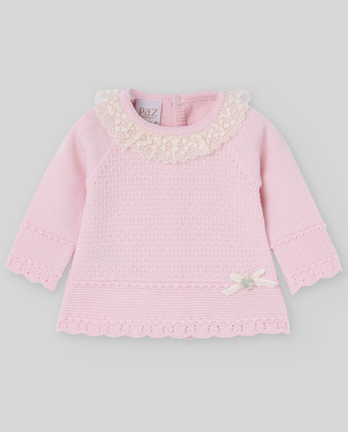 Pink baby dress with floral details on a gray background