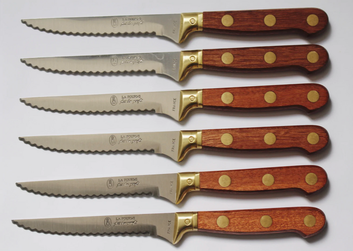 Brass knife set, six serrated knives with brass guards and wooden handles