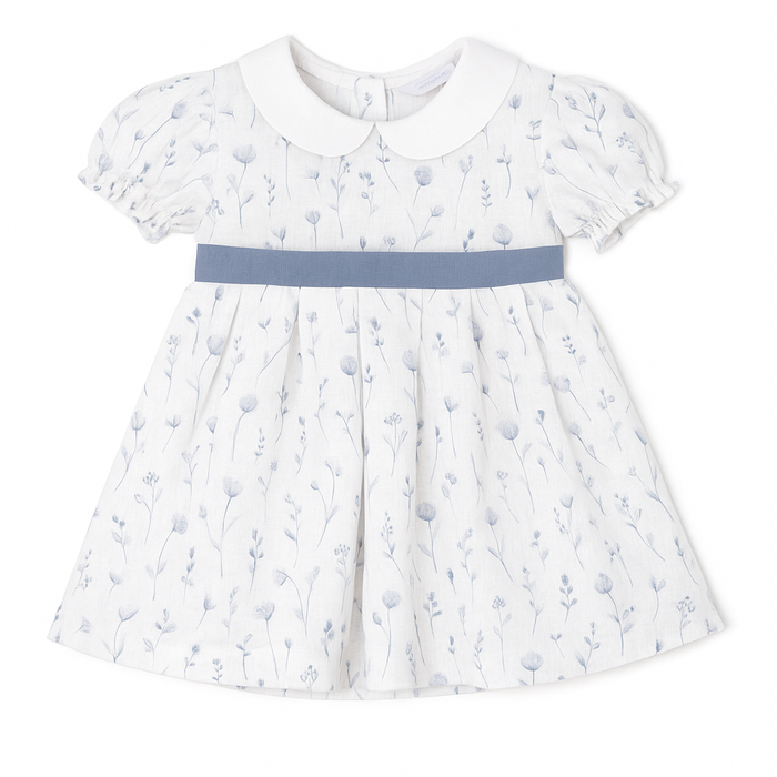White dress with blue floral pattern and blue belt on a white background