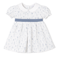 White dress with blue floral pattern and blue belt on a white background