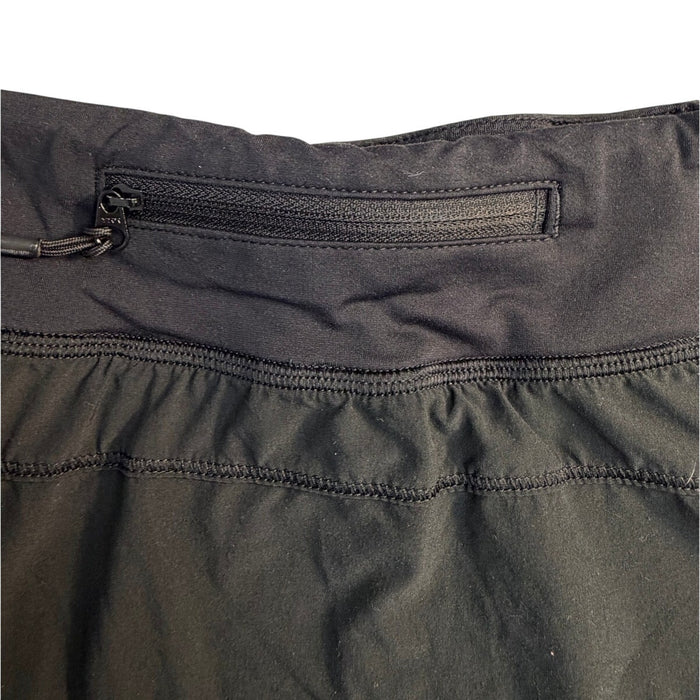 Black Lululemon women's skirt with built-in shorts, size 8, featuring a sleek, athletic design and comfortable fit.