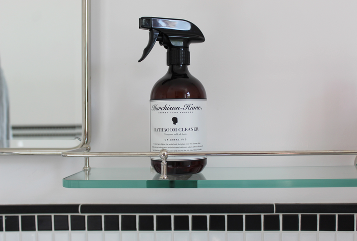 Bathroom cleaner spray bottle with black trigger, label facing forward on display