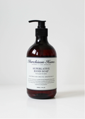 Amber hand soap bottle with black pump, labeled Australian White Grapefruit