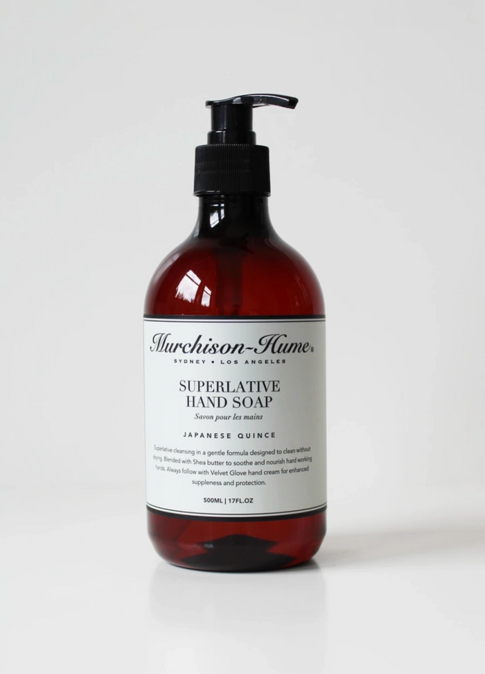 Amber hand soap bottle with black pump, labeled Japanese Quince