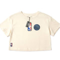 Women's cream NBA Golden State Warriors cropped T-shirt featuring team logo, displayed flat on a white background.