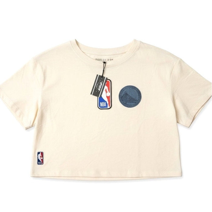 Women's cream NBA Golden State Warriors cropped T-shirt featuring team logo, displayed flat on a white background.