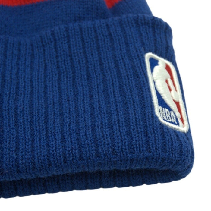 Youth blue and red New Era NBA Sacramento Kings pom beanie knit hat with team logo, warm winter headwear for basketball fans